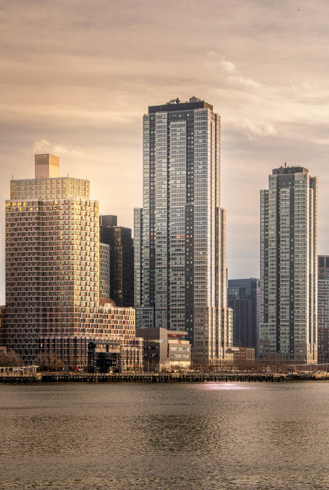 Book cover illustration of a suspense novel set among modern waterfront towers